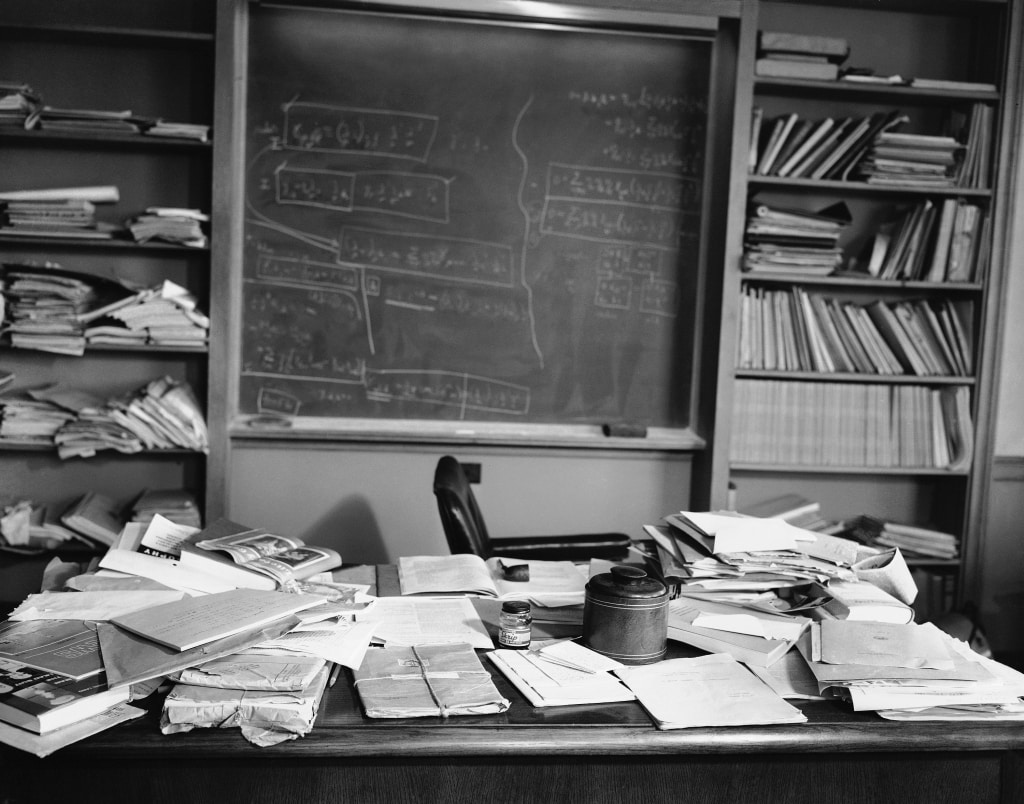 Familiar pipe on an open book, a cluttered desk and a blackboard covered with mathematical equations surround the empty chair in Dr. Albert Einsteins office at the Institute for Advanced Study, at Princeton, New Jersey on April 18, 1955. The famous physicist died of a gall bladder ailment at the age of 76. (AP Photo/Jacob Harris)