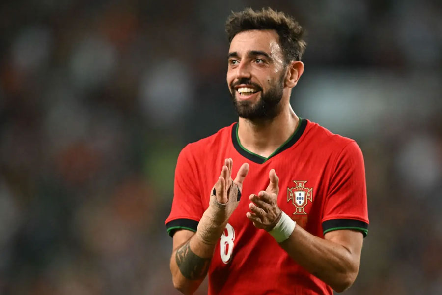 Manchester United and Portugal player Bruno Fernandes helps an unwell passenger during flight