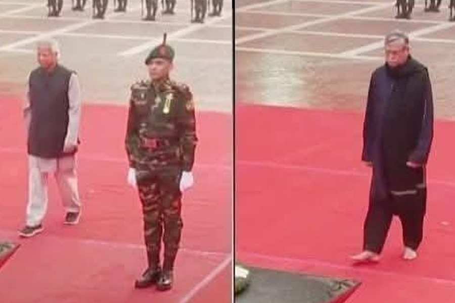 Muhammad Yunus wears shoes at the memorial in Bangladesh